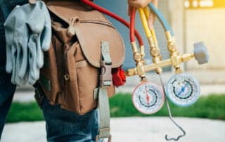 HVAC gages shown in an image as man is walking holding them.