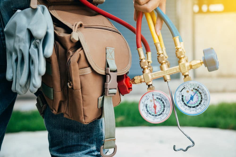 HVAC gages shown in an image as man is walking holding them.